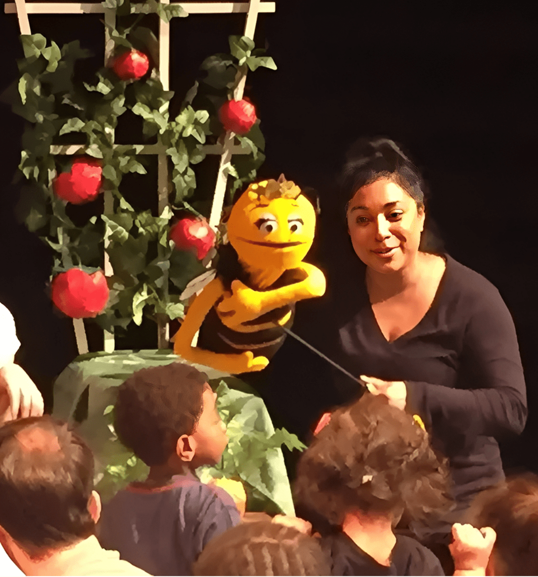 Performer with bee puppet and audience