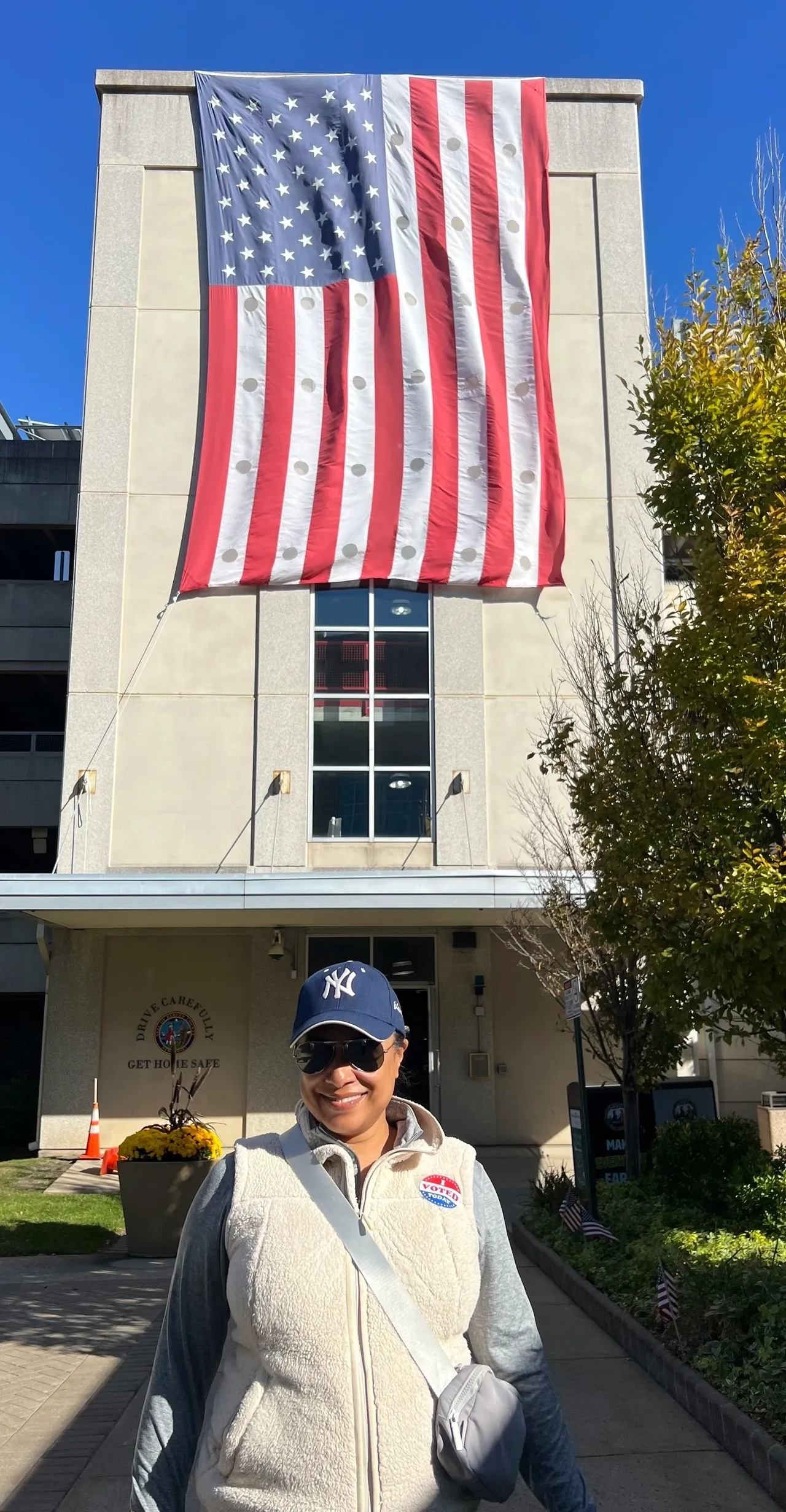 Person in front of building with flag