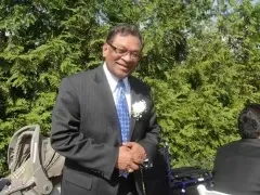 Man with glasses and blue tie